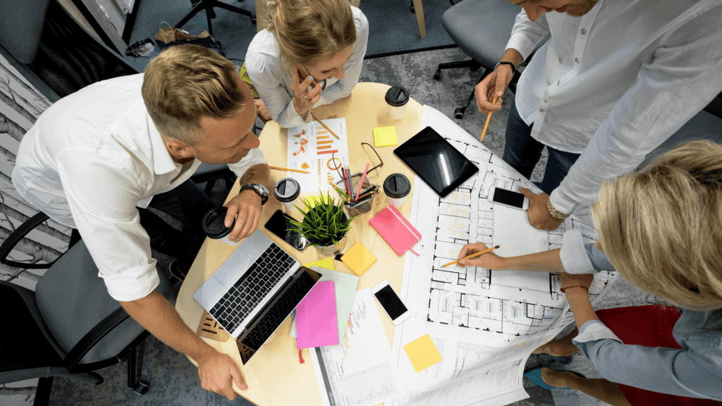 agile team working on a project with sticky notes over the table