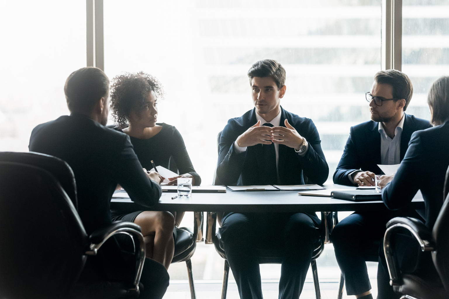 Executives in a boardroom discussing enterprise architecture and business alignment.