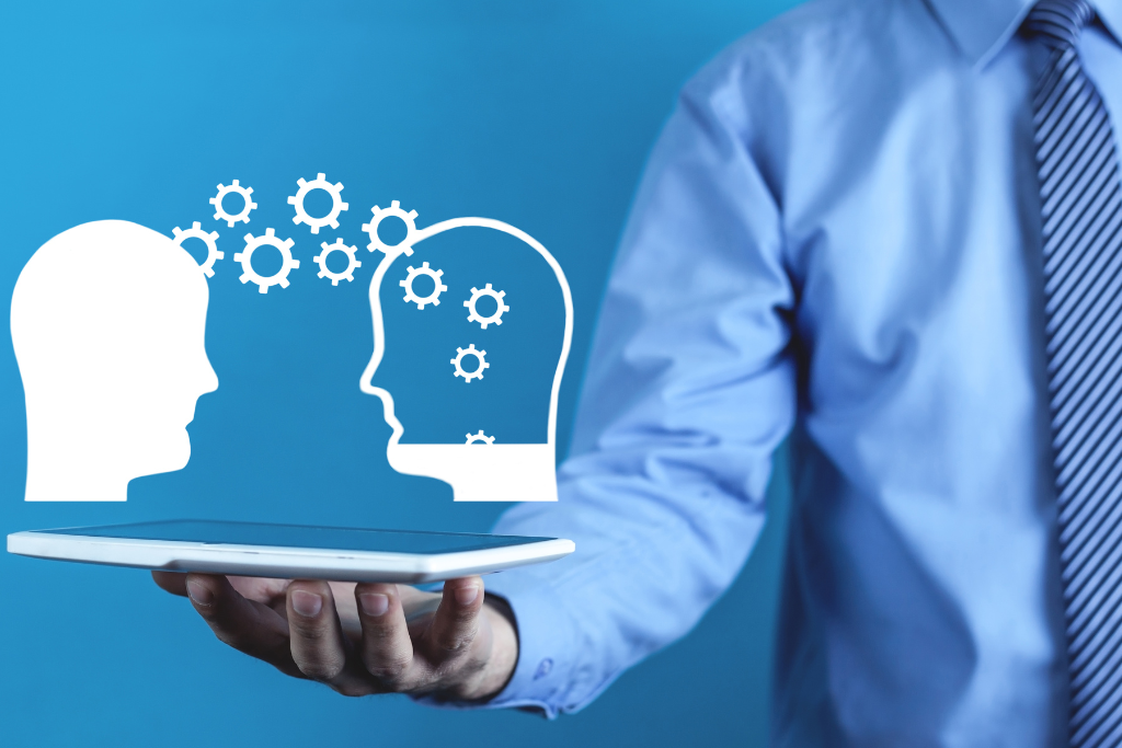 knowledge transfer between two heads with gears on a digital tablet